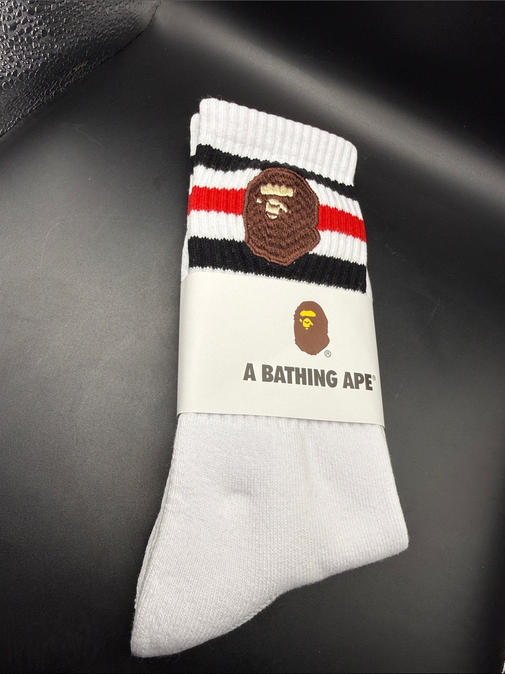 A Bathing Ape White Crew Socks with Red & Black Stripe and Ape Logo